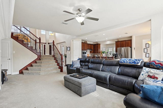 living room featuring ceiling fan and light colored carpet