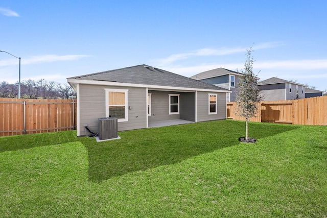 back of house featuring a patio area, a yard, and central AC unit