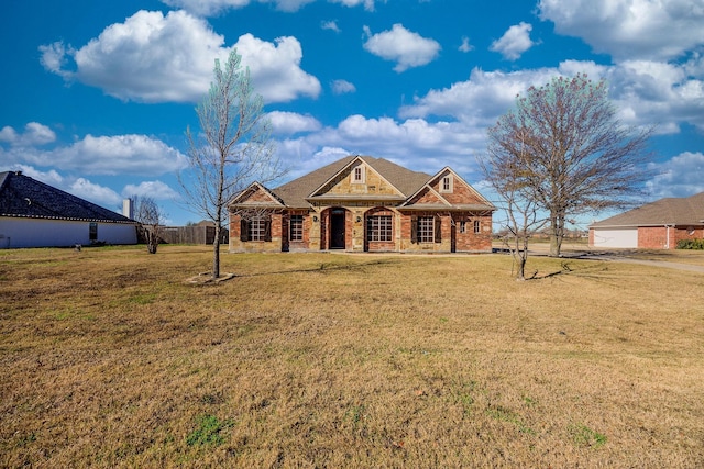 ranch-style home with covered porch and a front lawn