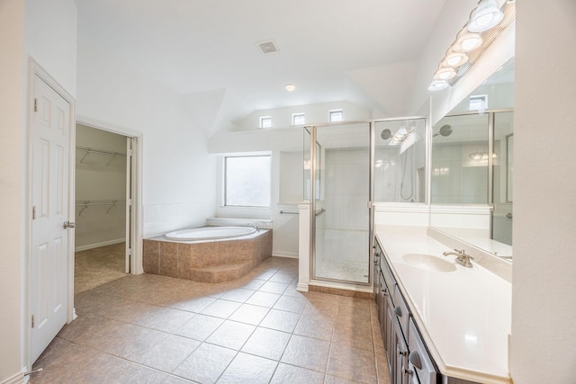 bathroom with tile patterned floors, vanity, and separate shower and tub