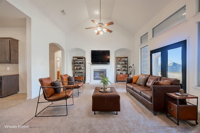 living room with light carpet, high vaulted ceiling, and ceiling fan