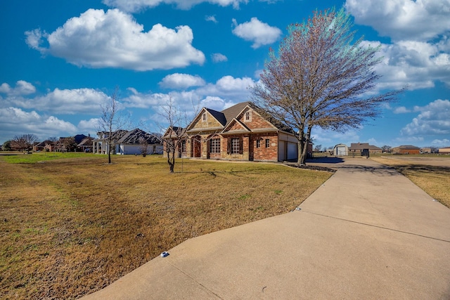 view of front of house featuring a front yard and a garage