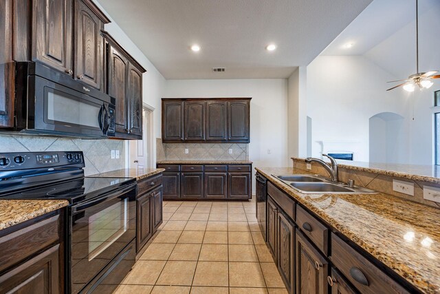 kitchen featuring decorative backsplash, dark brown cabinets, sink, black appliances, and light tile patterned floors