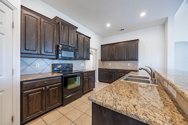 kitchen with decorative backsplash, dark brown cabinets, sink, black appliances, and light tile patterned floors