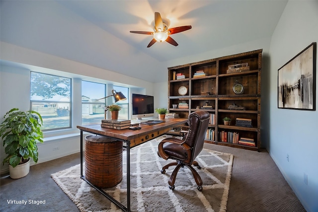 carpeted home office featuring ceiling fan and lofted ceiling