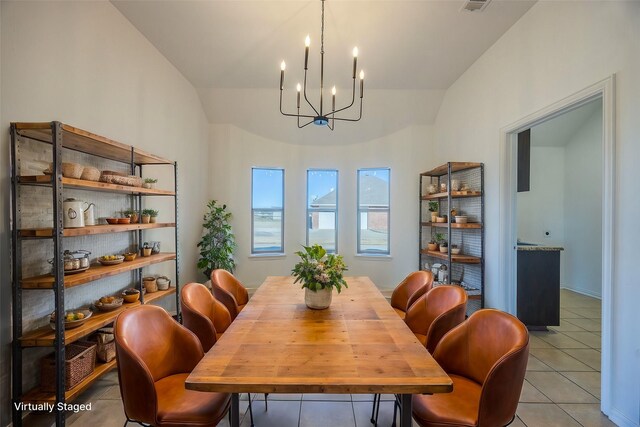 dining area featuring an inviting chandelier, vaulted ceiling, and light tile patterned flooring