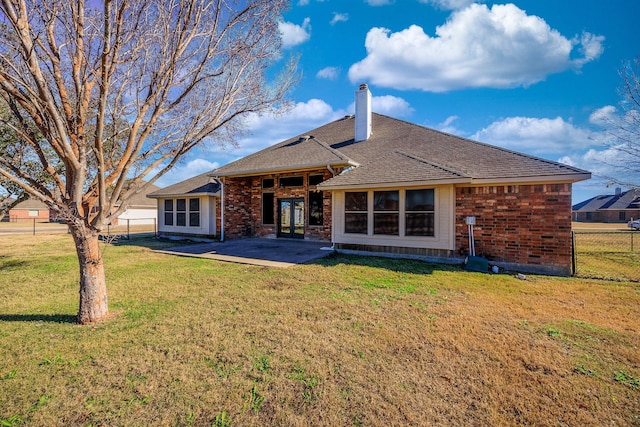 back of house with a patio and a lawn