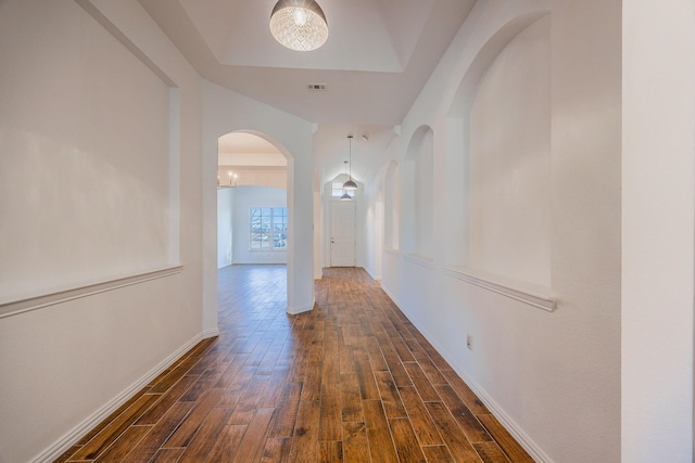 corridor featuring a raised ceiling