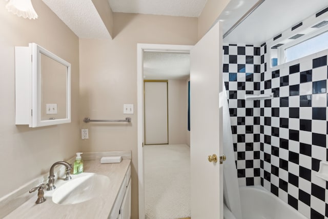 bathroom with vanity, shower / tub combo, and a textured ceiling