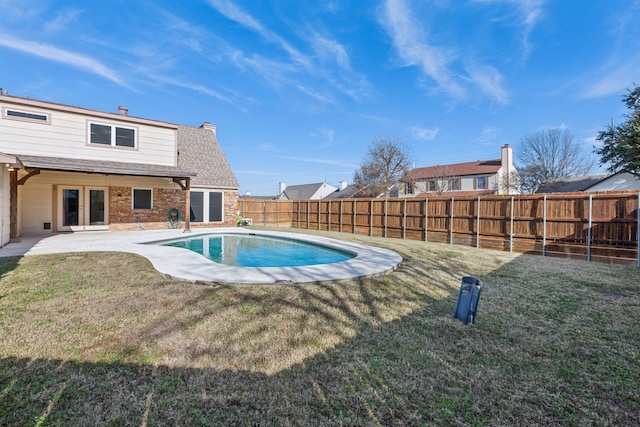 view of pool with a yard and a patio