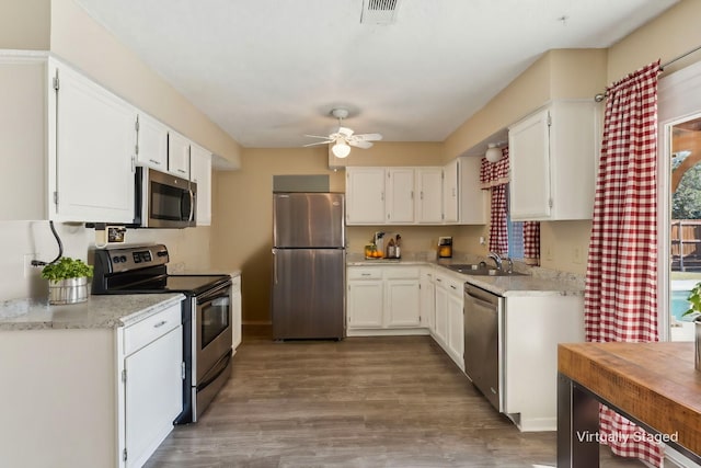 kitchen featuring white cabinets, sink, and appliances with stainless steel finishes