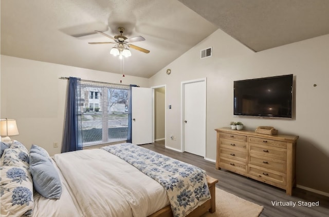 bedroom featuring ceiling fan, dark hardwood / wood-style flooring, and lofted ceiling