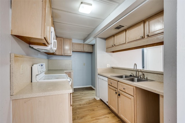 kitchen with sink, light brown cabinets, and white appliances