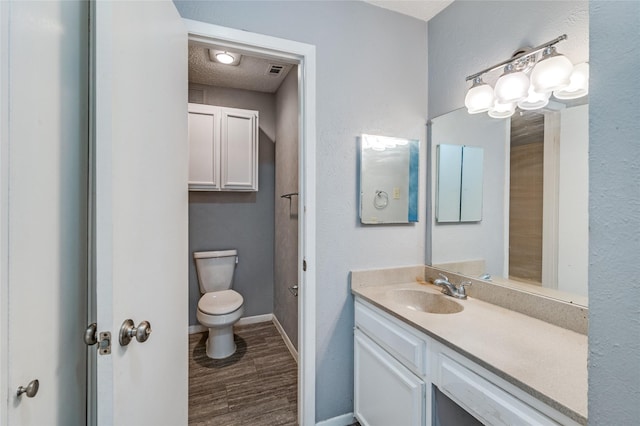 bathroom featuring vanity, hardwood / wood-style floors, and toilet