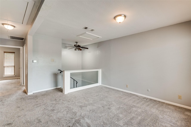 carpeted empty room featuring a textured ceiling