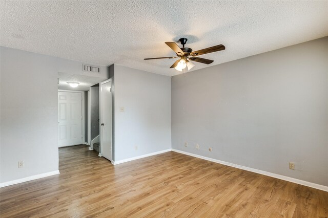 unfurnished room with ceiling fan, a textured ceiling, and light hardwood / wood-style flooring