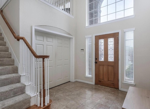 foyer featuring a towering ceiling