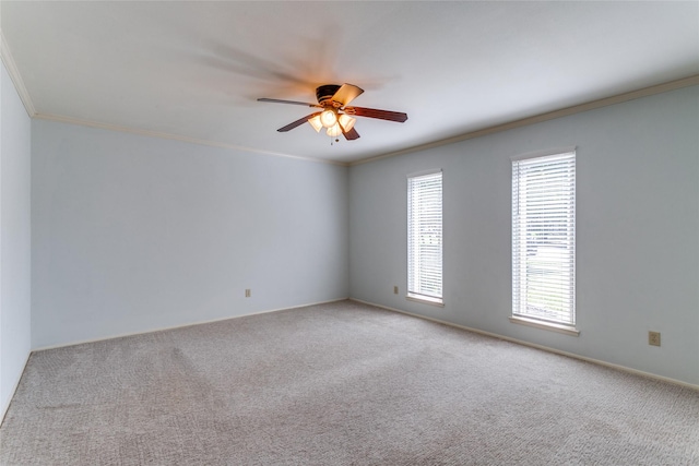 empty room featuring carpet flooring, ceiling fan, and ornamental molding