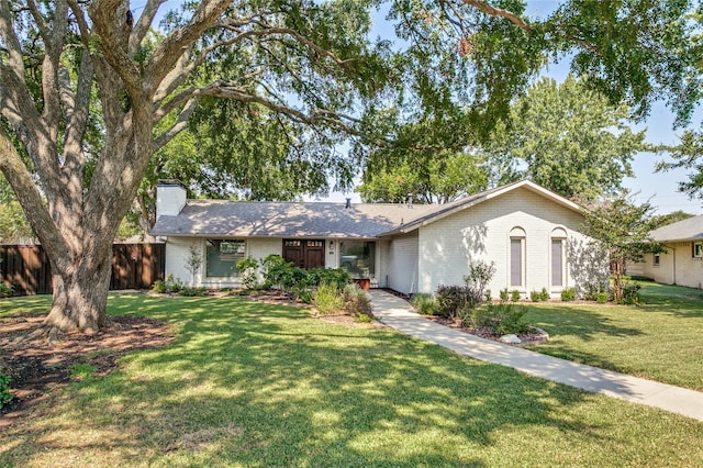 single story home with a front lawn