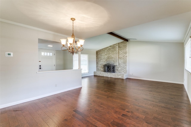 unfurnished living room with vaulted ceiling with beams, a notable chandelier, dark hardwood / wood-style floors, and a brick fireplace