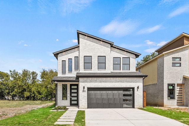 view of front of property with a garage and a front lawn