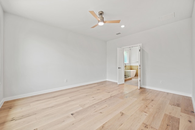 unfurnished room with ceiling fan and light hardwood / wood-style floors