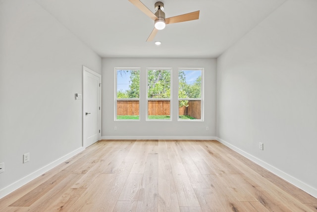 spare room with ceiling fan and light hardwood / wood-style flooring