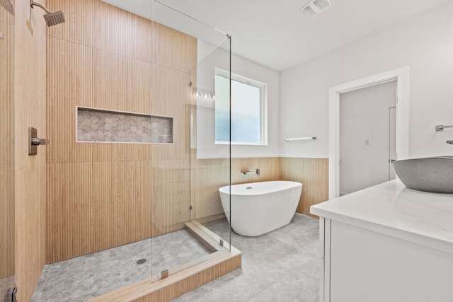 bathroom with vanity, wooden walls, tile patterned floors, and independent shower and bath