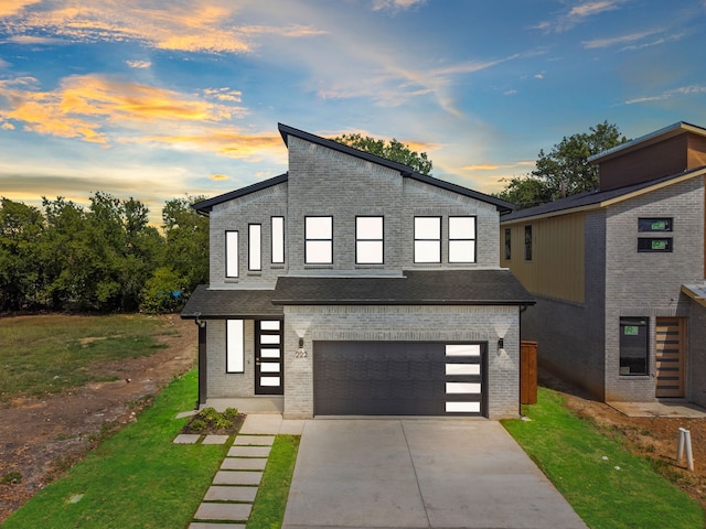 contemporary house with a garage and a yard