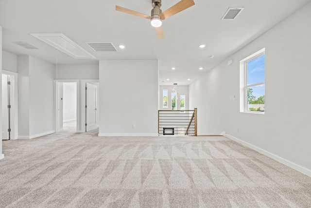 unfurnished room featuring ceiling fan and light colored carpet