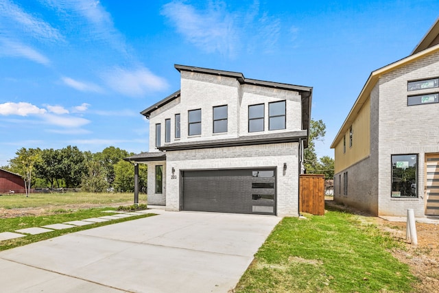 view of front of home with a front yard and a garage