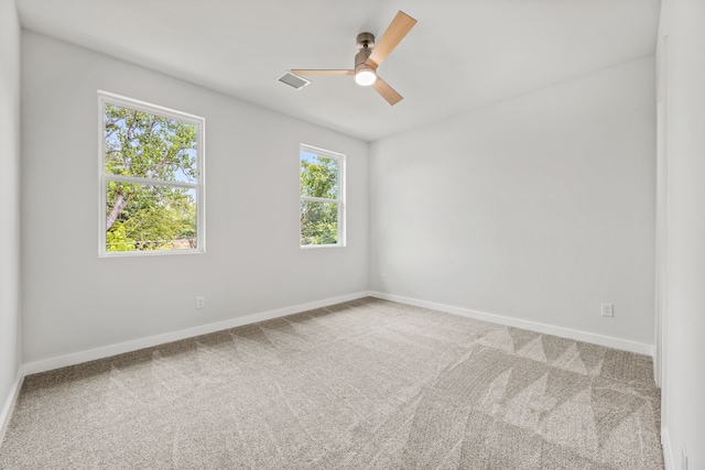 carpeted empty room featuring ceiling fan