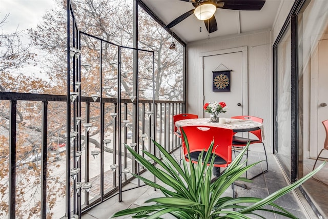 unfurnished sunroom featuring ceiling fan