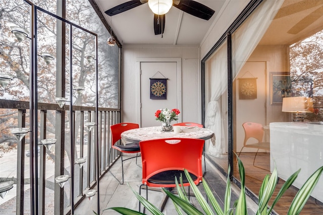 sunroom / solarium featuring ceiling fan