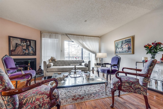 living room with hardwood / wood-style floors and a textured ceiling