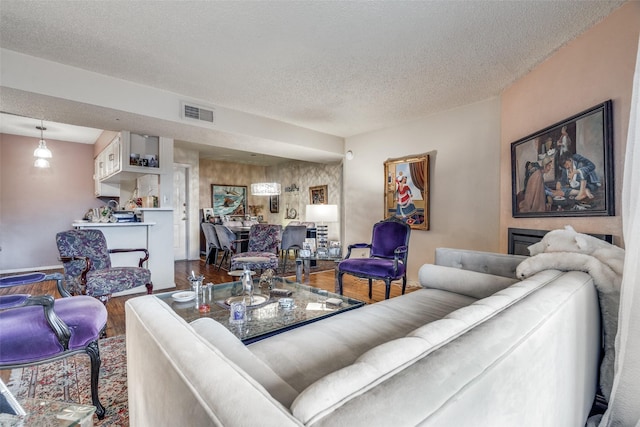 living room with wood-type flooring and a textured ceiling