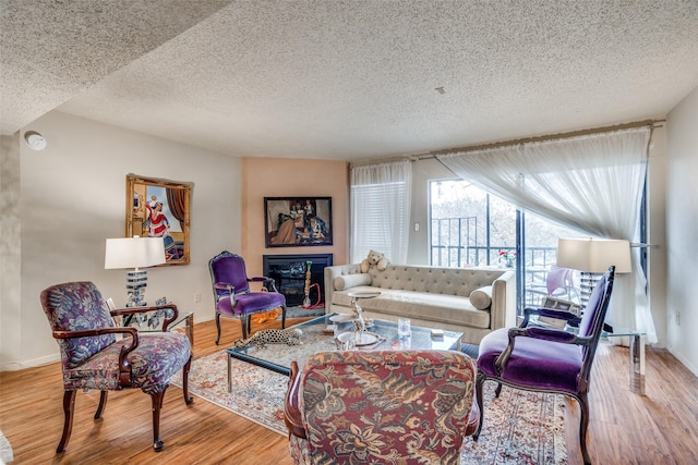 living room featuring hardwood / wood-style floors and a textured ceiling