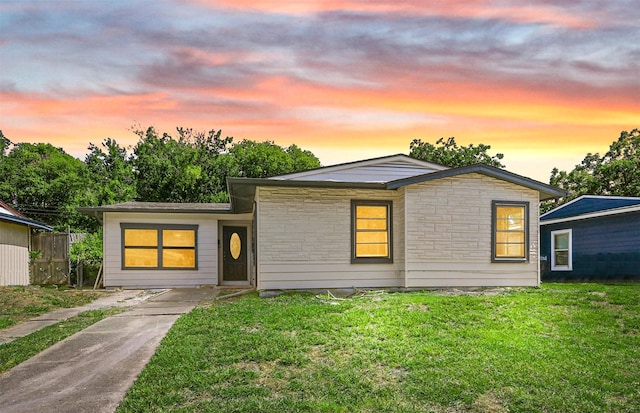 ranch-style home with a yard