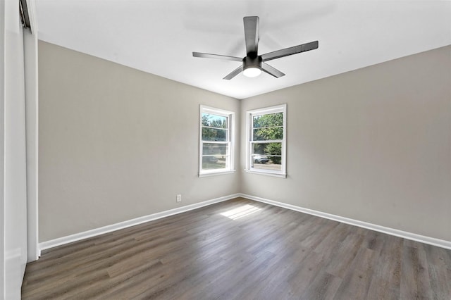 spare room with ceiling fan and dark hardwood / wood-style flooring