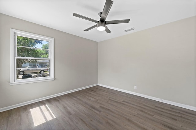 empty room featuring dark hardwood / wood-style floors and ceiling fan