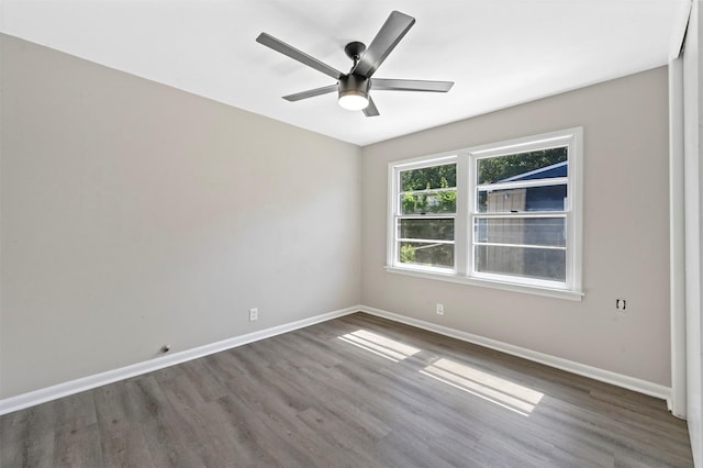 unfurnished room featuring ceiling fan and dark hardwood / wood-style flooring