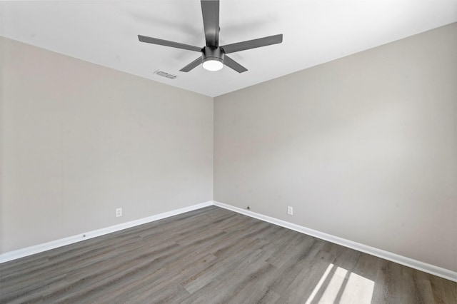 spare room with dark hardwood / wood-style flooring