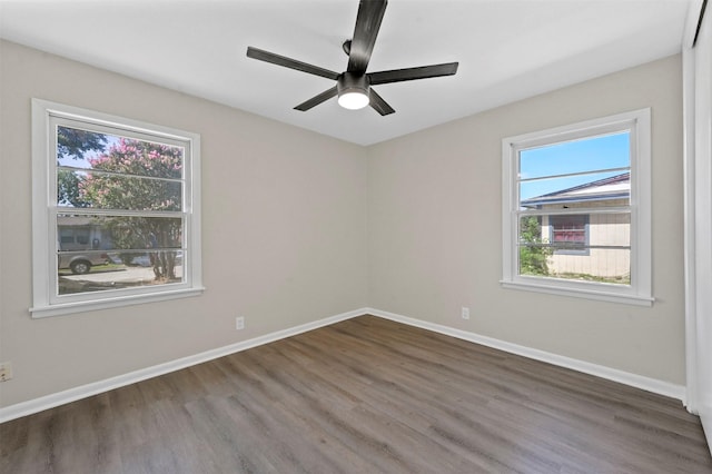 spare room featuring ceiling fan and dark wood-type flooring