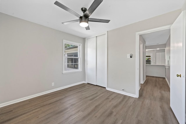 unfurnished bedroom featuring light wood-type flooring, a closet, and ceiling fan