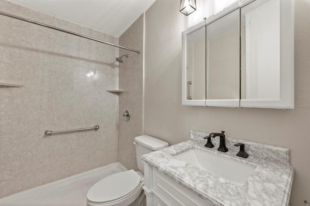 bathroom with walk in shower, vanity, and toilet