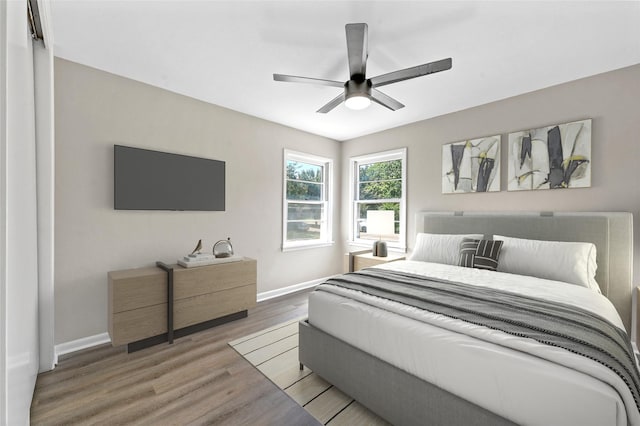 bedroom with ceiling fan and wood-type flooring