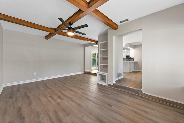 unfurnished living room with ceiling fan, dark hardwood / wood-style flooring, beamed ceiling, and coffered ceiling