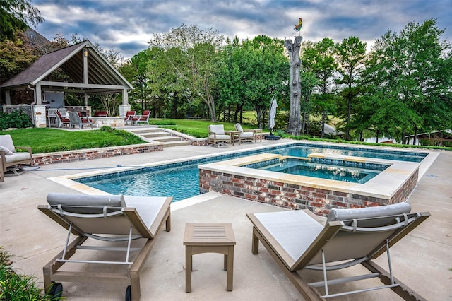 view of swimming pool with an in ground hot tub and a patio area