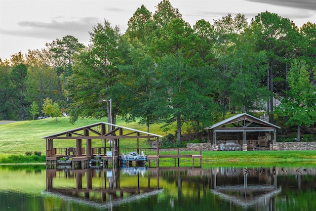 view of dock with a gazebo, a water view, and a lawn