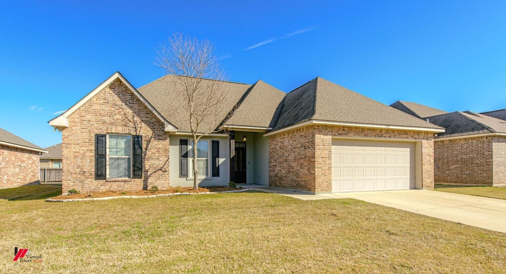 view of front of house featuring a garage and a front lawn